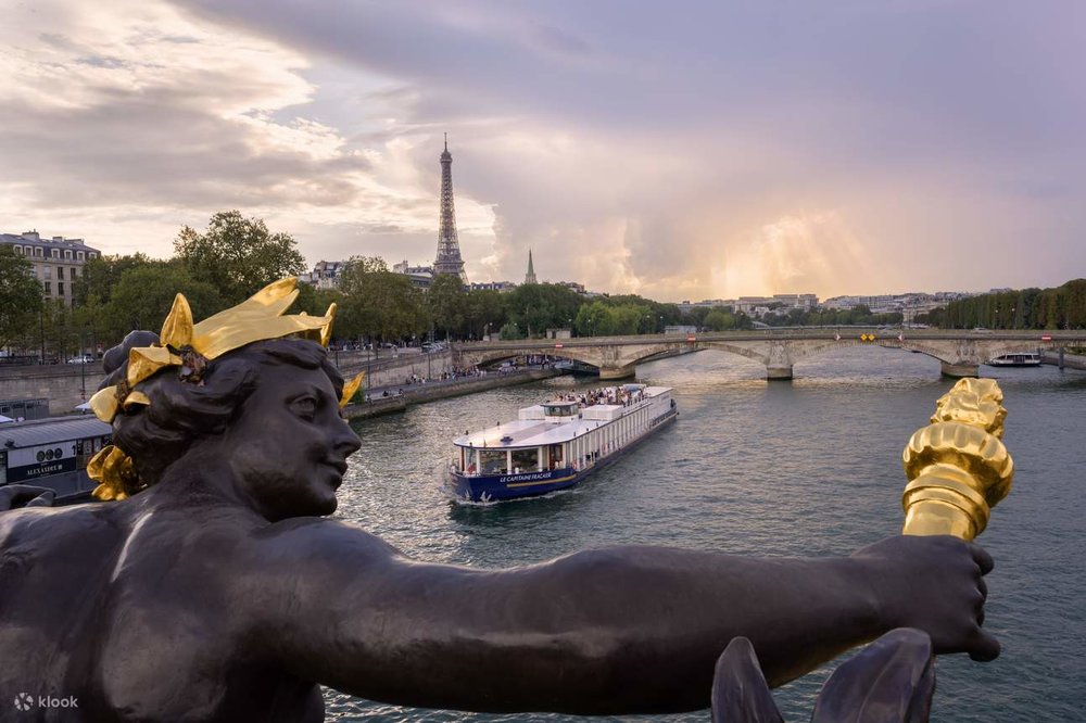 A boat cruising along the Seine, with the Eiffel Tower seen from afar