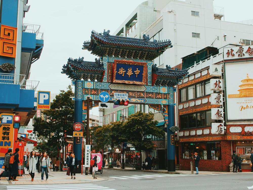 Colorful Yokohama Chinatown gate with shops and pedestrians