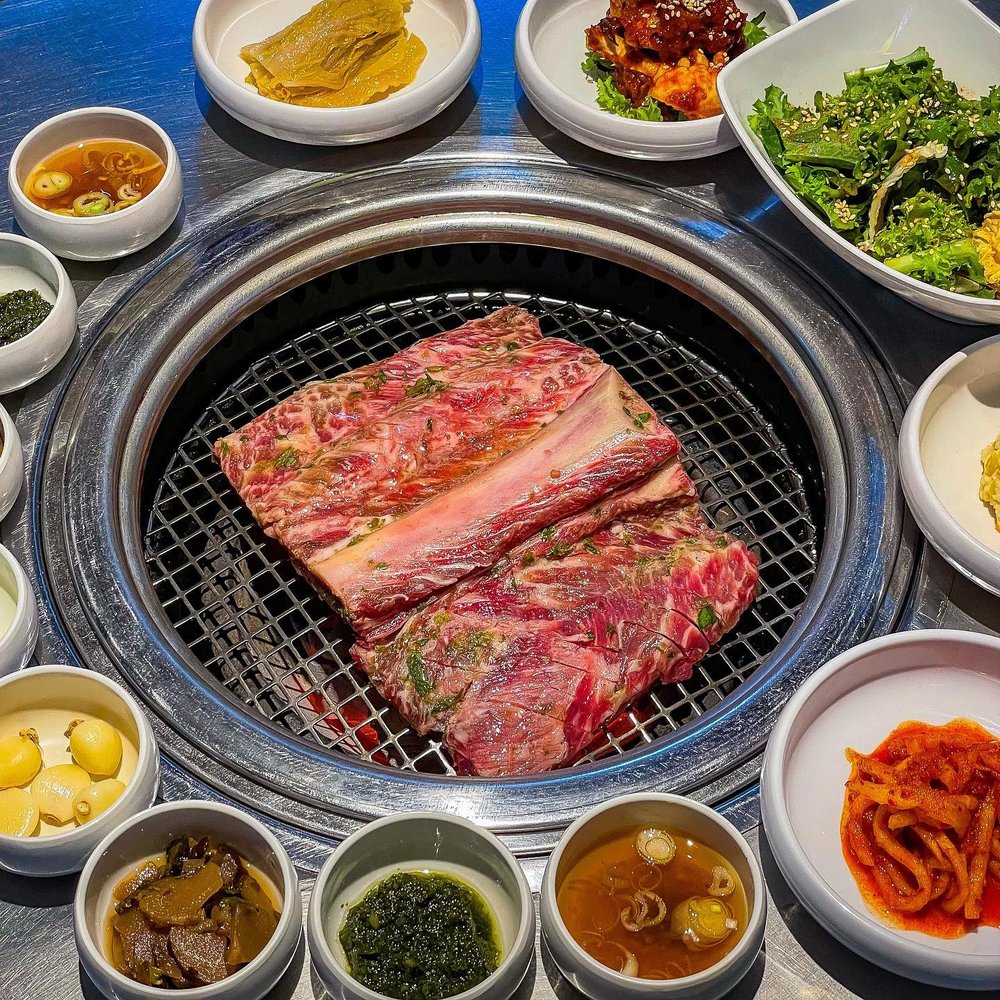 Grilled meat, side dishes, and dips at Chungkiwa Town in Seoul.