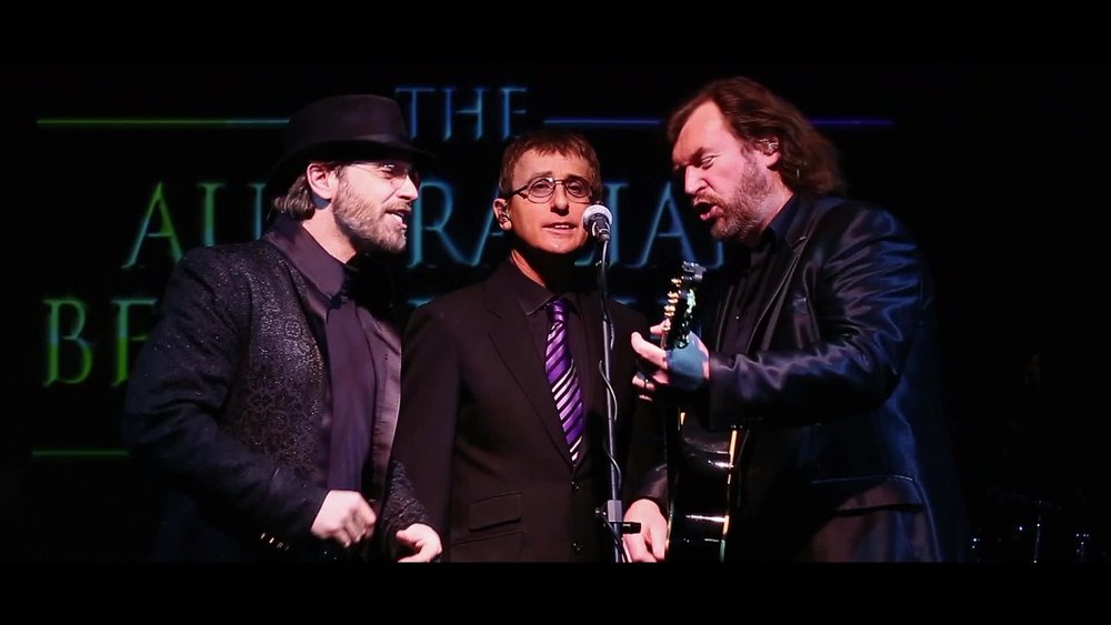 Three men singing a Bee Gees song