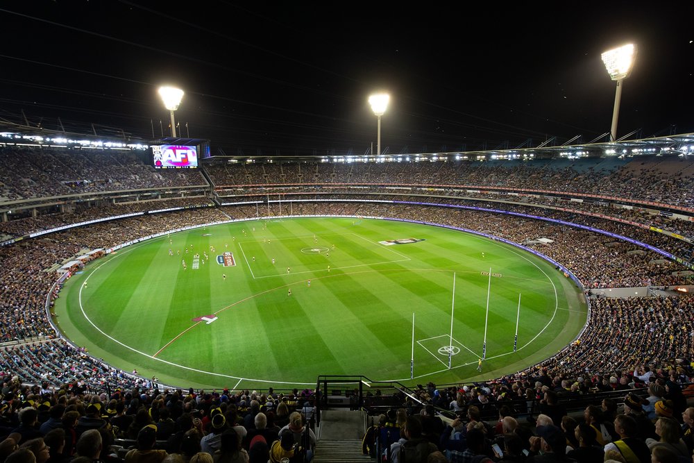 A big audience watching a game at the Melbourne Cricket Ground.