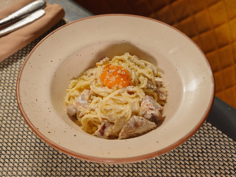 Classic Italian carbonara topped off with egg