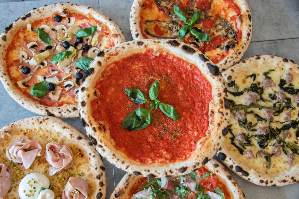 An assortment of fresh Italian pizzas
