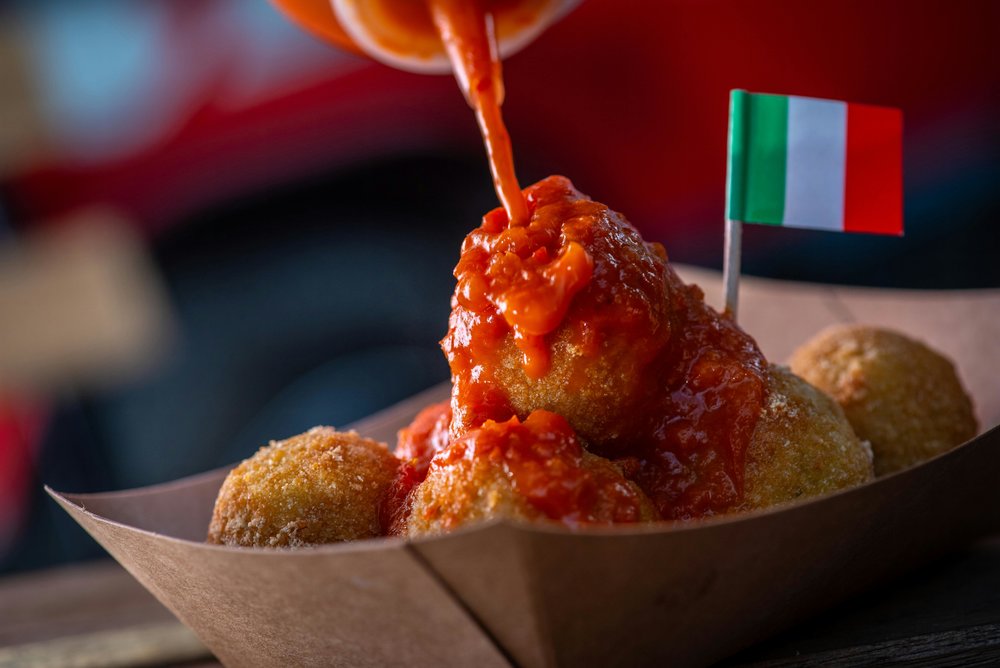 Italian arancini drizzled with rich tomato sauce