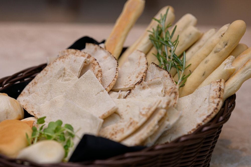 Crispy flatbread with breadsticks on a basket