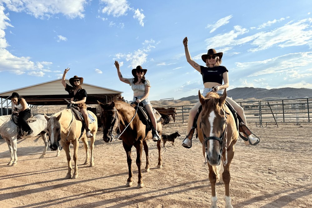 Tourists enjoying a sunset horseback ride tour