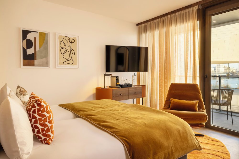 Warm modern suite at Hotel 56 Bordeaux with balcony and river views