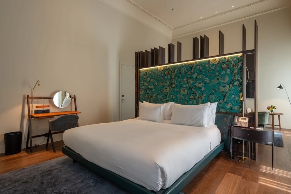 Luxury room with artistic headboard at Hotel Mercer Sevilla
