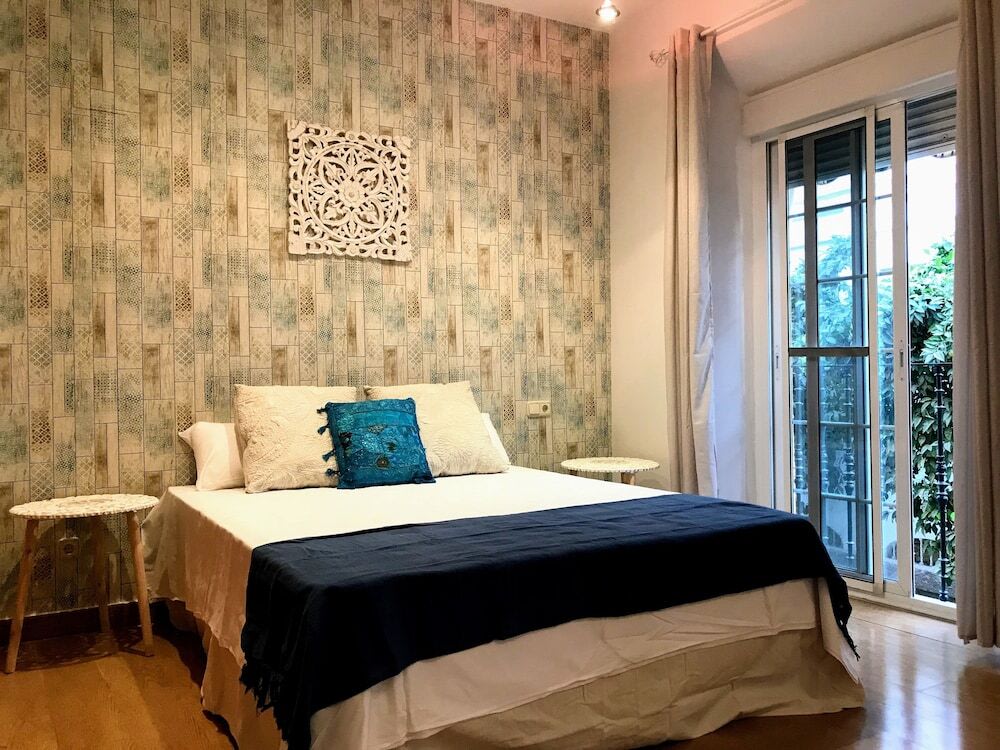 Cozy bedroom with balcony at Triana Luxury Home Seville