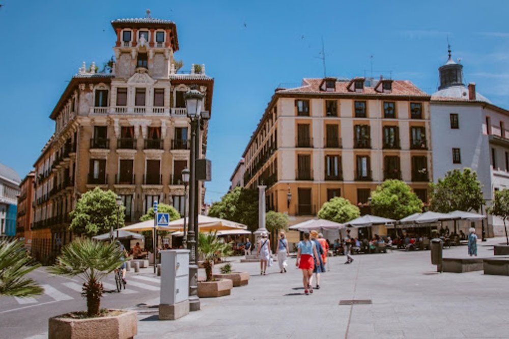 People walking on a sunny Madrid street | Photo by Luis Quintero on Pexels