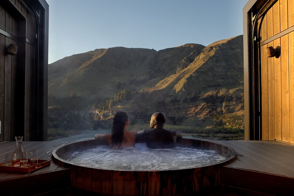 A couple enjoying a warm bath at the Onsen Hot Pools in Queenstown.