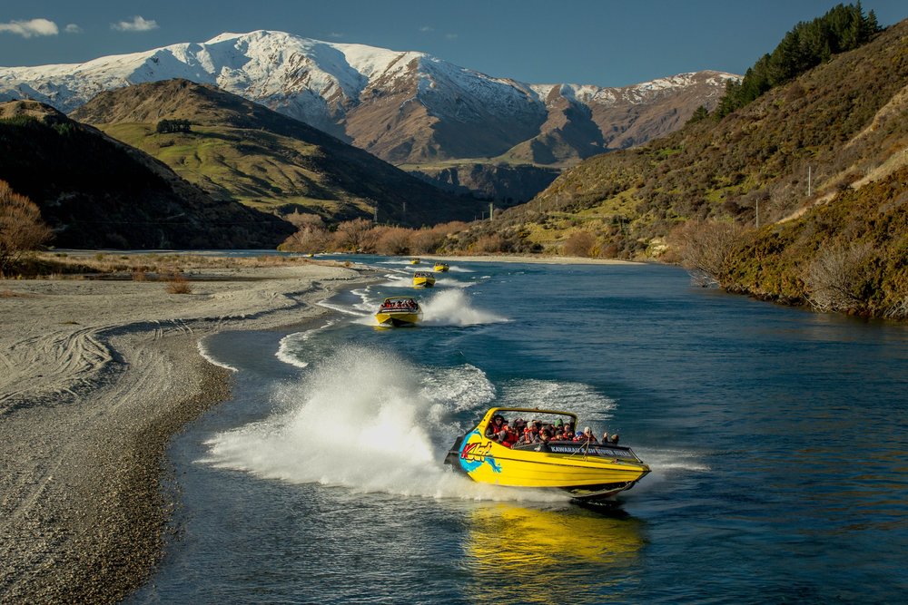 A group of people on a high-speed jet boat at Lake Wakatipu.