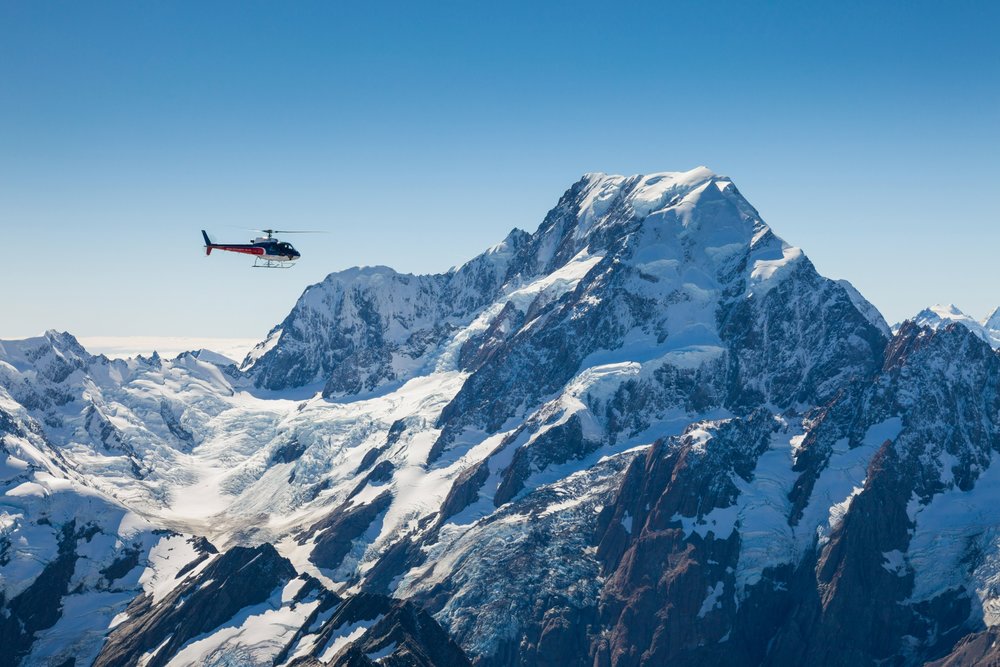 A helicopter flying above Aoraki Mt. Cook.