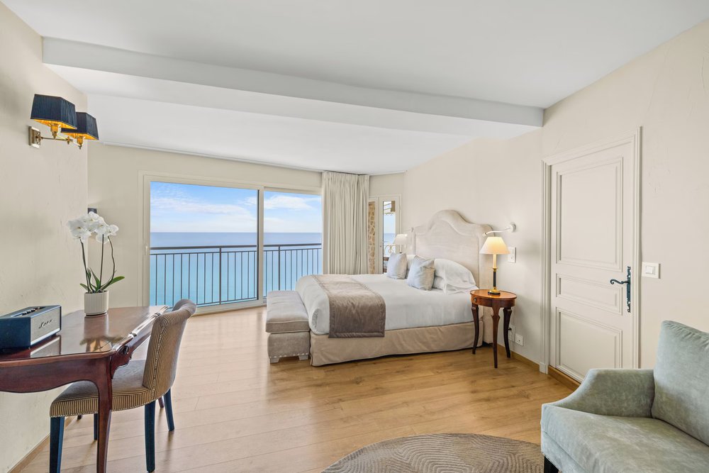 A spacious hotel room with balcony in Chateau de la Chevre d'Or