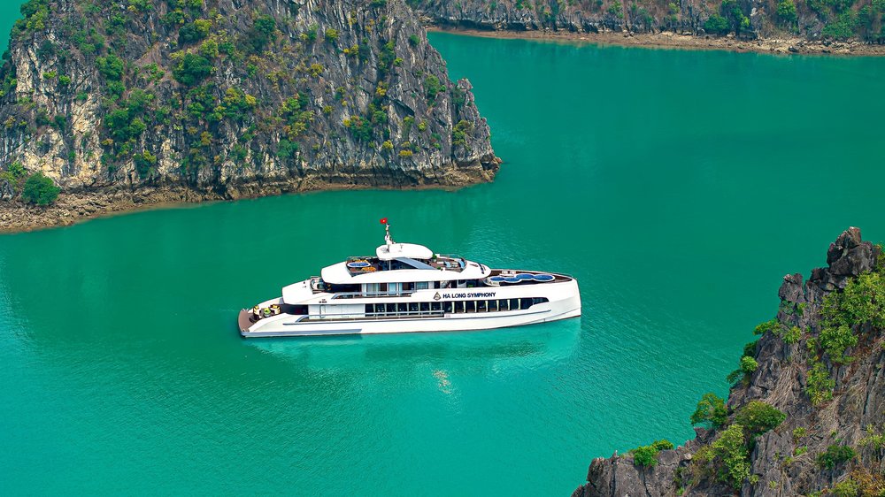 Halong Bay Symphony cruise sailing through emerald waters and limestone cliffs