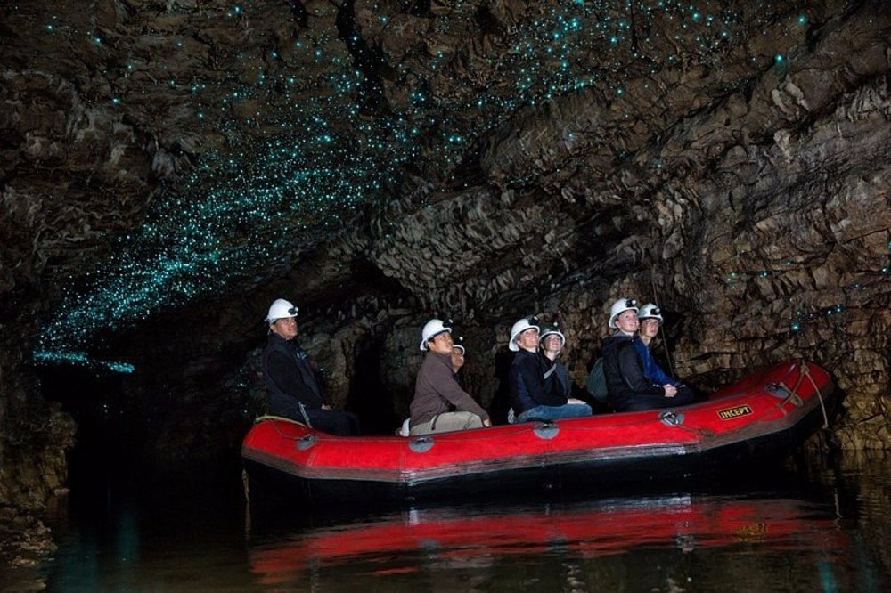 Boat ride through Waitomo Glowworm Caves illuminated by glowworms