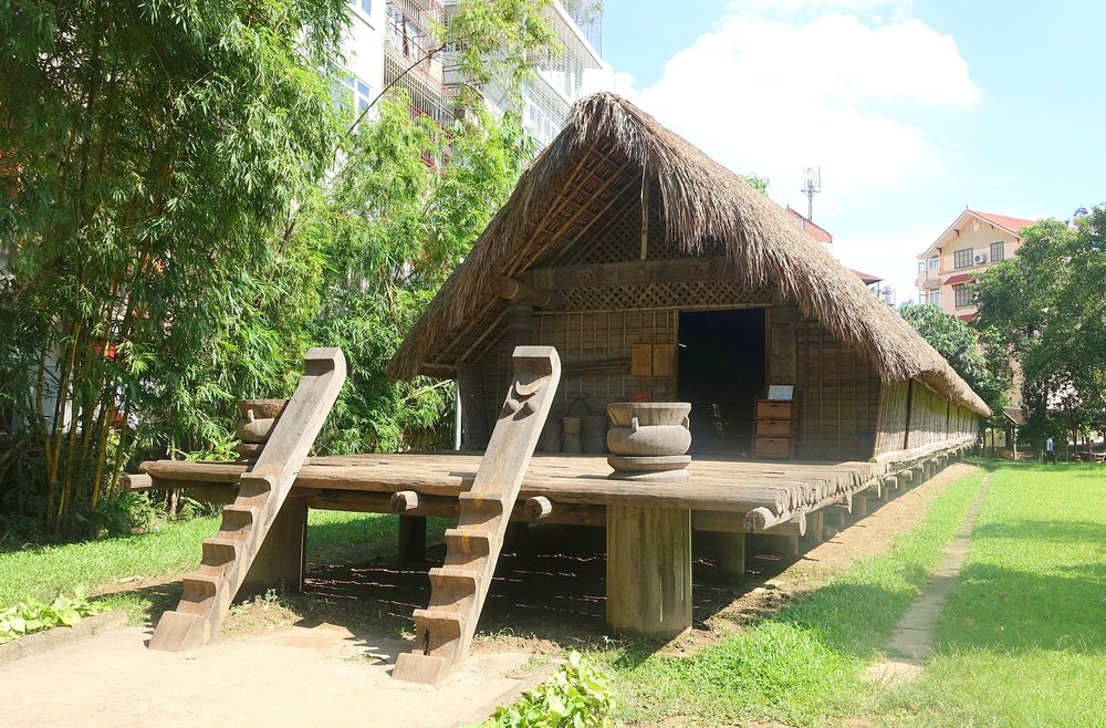 Traditional stilt house displayed outdoors at the Vietnam Museum of Ethnology in Hanoi