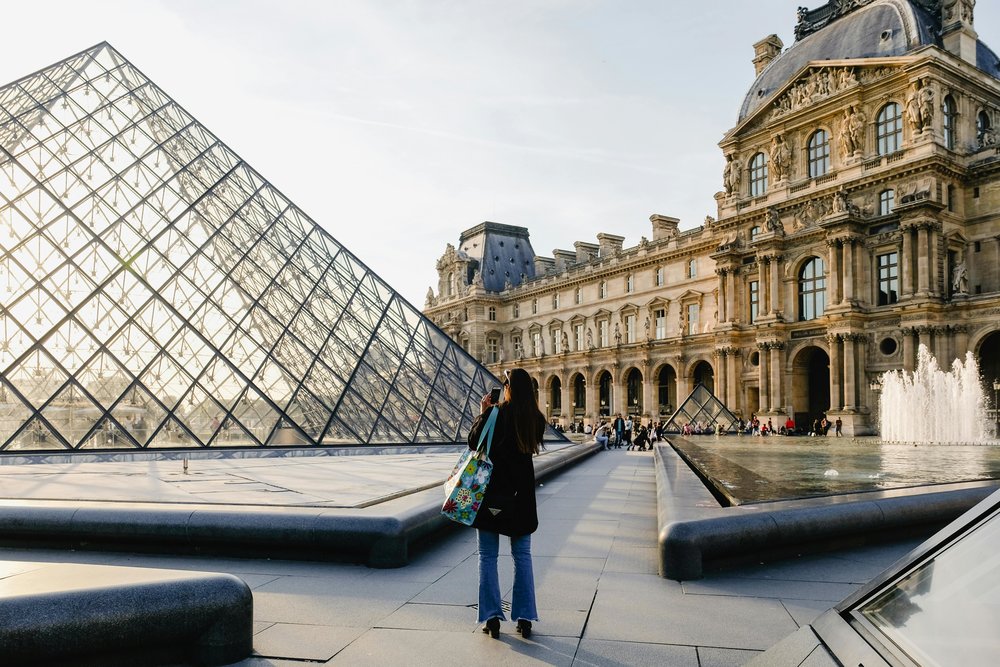Louvre Museum and glass pyramid at sunset