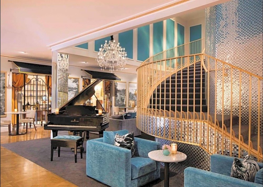 Elegant lobby with grand piano and chandelier in Sofitel Queenstown Hotel & Spa