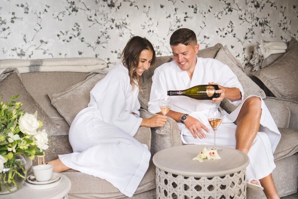 Couples enjoying champagne in the Cave Spa in Gibbston Valley Lodge & Spa
