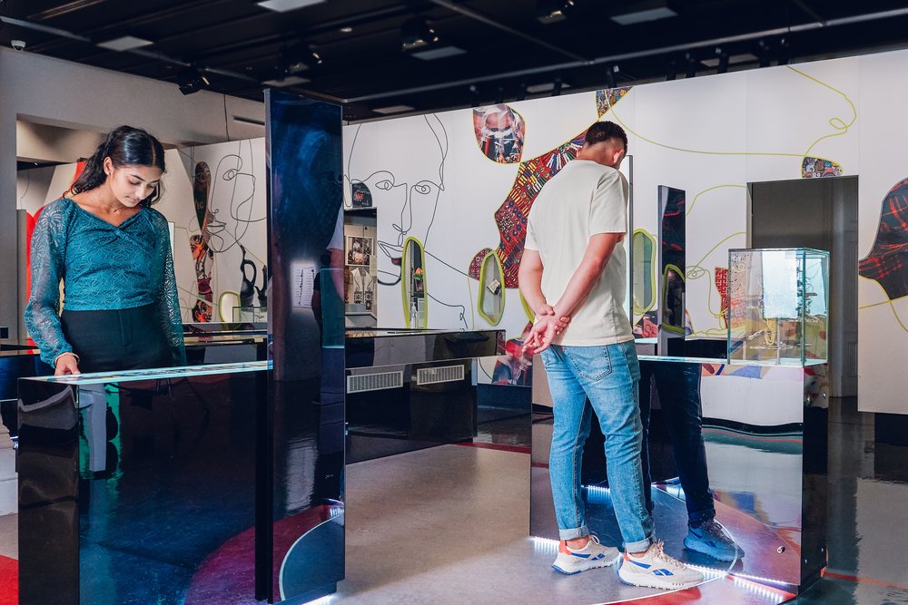 Visitors explore contemporary exhibits in Immigration Museum