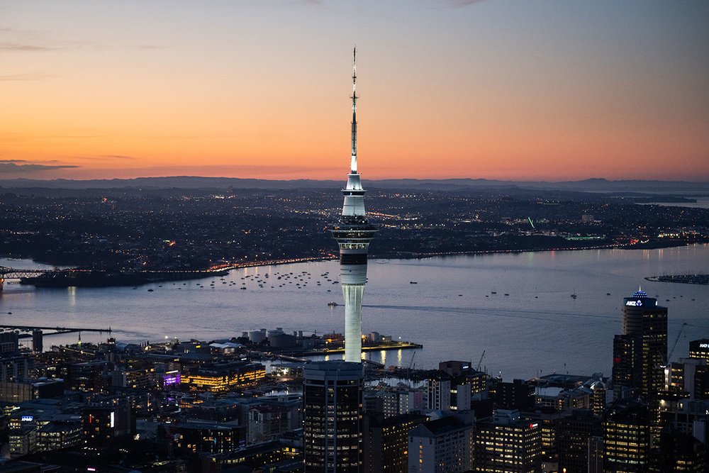 Auckland skyline glowing at sunset with Sky Tower views