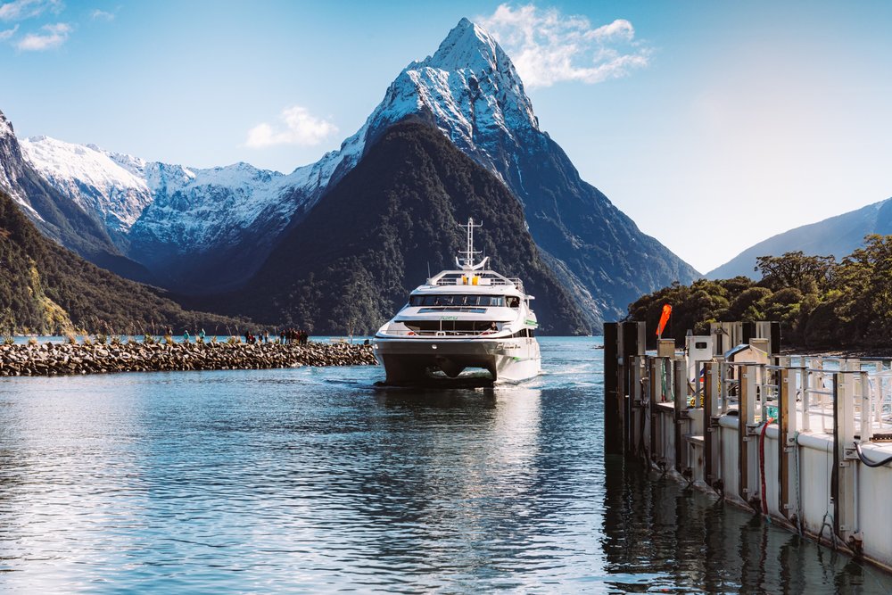 Cruise boat arriving beneath Mitre Peak in Milford Sound