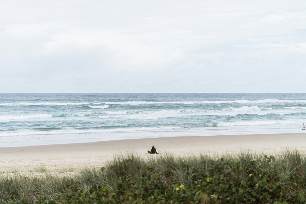 A person sitting in front of the beach in Australia
