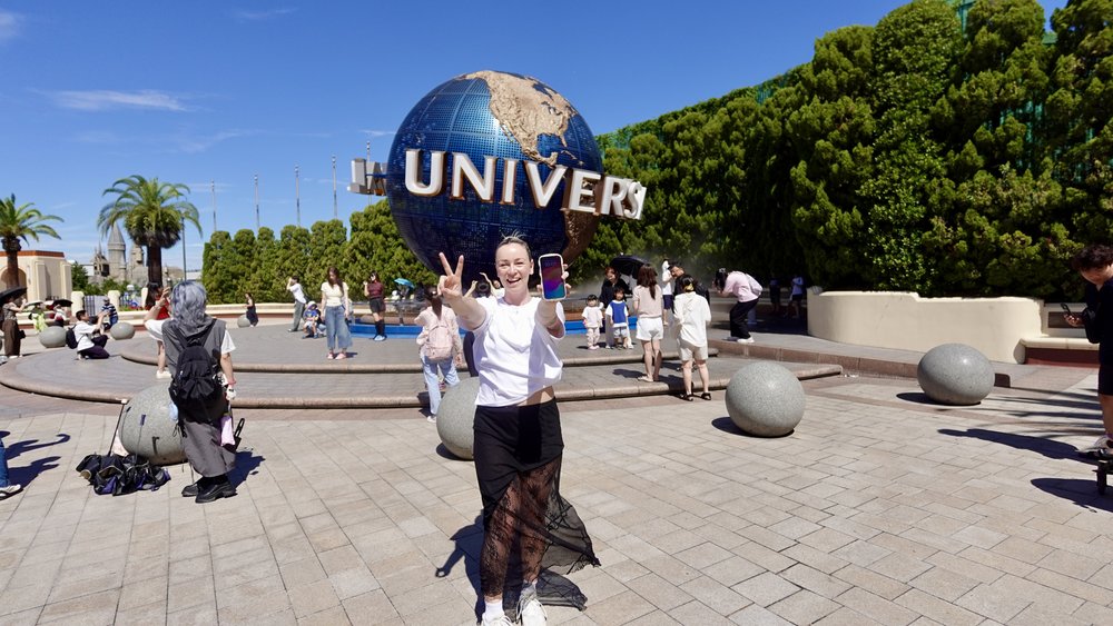 Woman in front of Universal globe in USJ