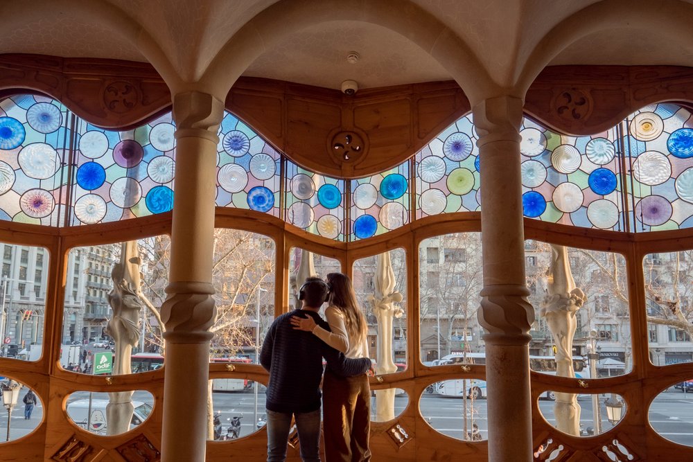 Visitors admire Casa Batlló’s stained-glass gallery overlooking Passeig de Gràcia in Barcelona