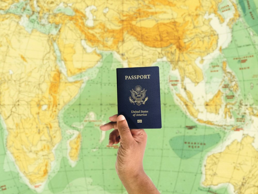 Holding a US passport with a map in the background
