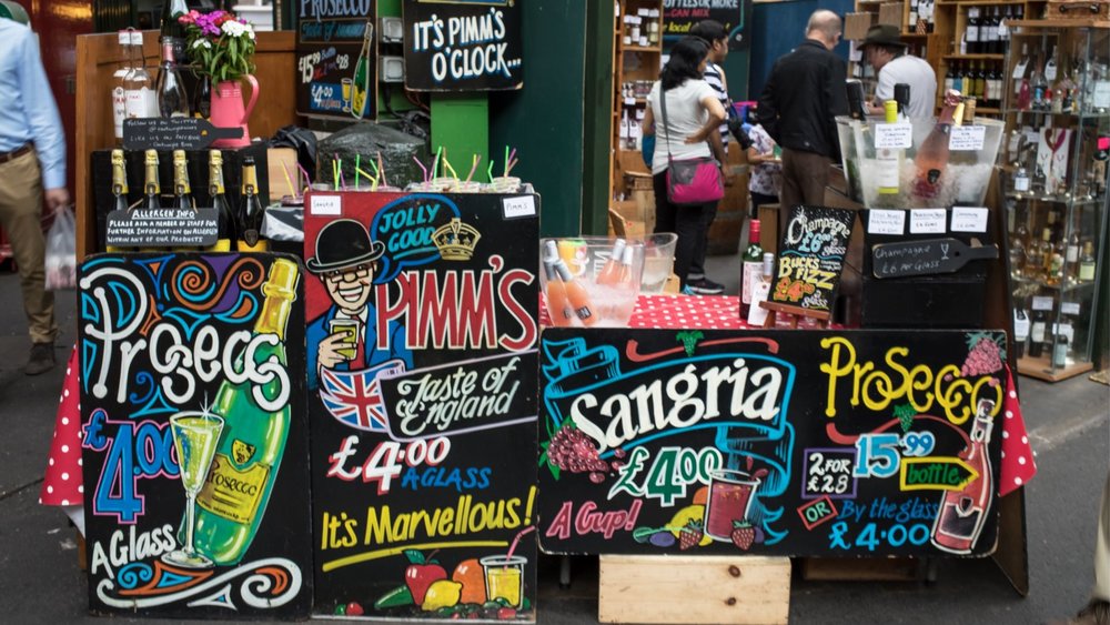 Colorful drink displays and market stalls at Borough Market in London