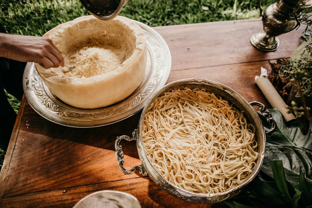 Pasta and a hollowed wheel of cheese
