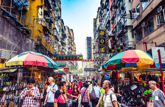 People walking along the streets of Hong Kong packed with stalls