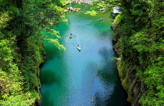 people kayaking through a gorge