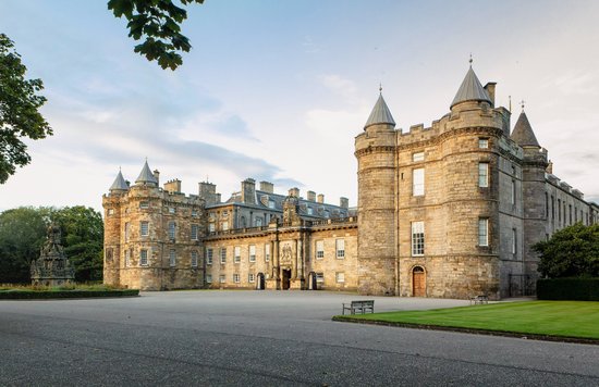 Front view of Holyrood Palace with towers and courtyard at sunset