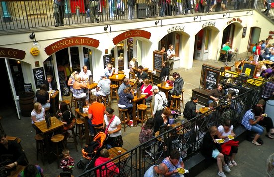 Crowded London pub with outdoor seating, people eating and drinking in central London.