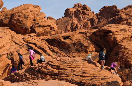 Visitors exploring red sandstone formations at Valley of Fire State Park