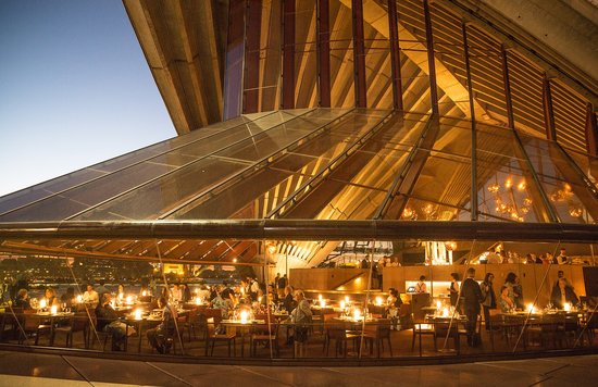 Elegant restaurant inside the Sydney Opera House overlooking Sydney Harbour at night