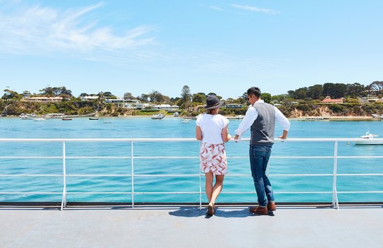 Couple standing by the water on a scenic Mornington Peninsula coastal escape