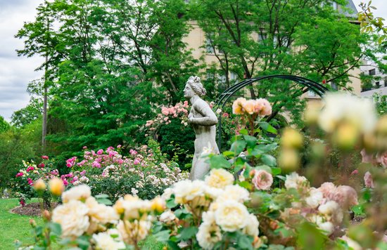 Classic sculpture set in the roses of the Jardin des Plantes in Paris