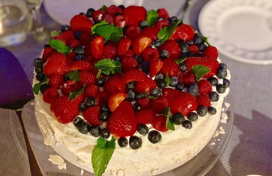 Pavlova dessert with strawberries, blueberries, and cream in New Zealand