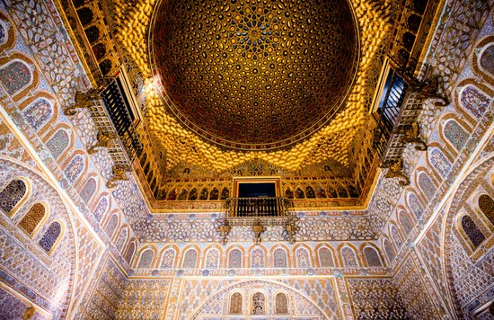 Ornate golden dome and patterned walls inside a historic palace in Seville | Photo Credit: Akshay Nanavati on Unsplash