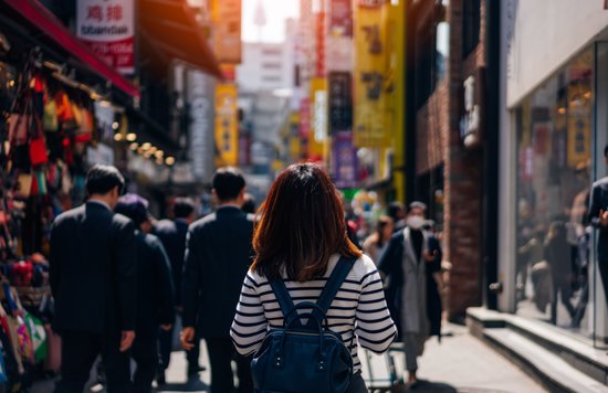 Solo traveler walking through Myeongdong street