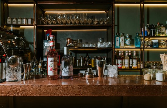 Stylish bar setup with gin bottles and glassware in Auckland bar