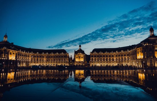 Bordeaux city center at night reflected in the Water Mirror | Photo Credit: Juan Di Nella on Unsplash