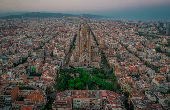 Barcelona skyline aerial featuring Sagrada Familia and surrounding neighborhoods
