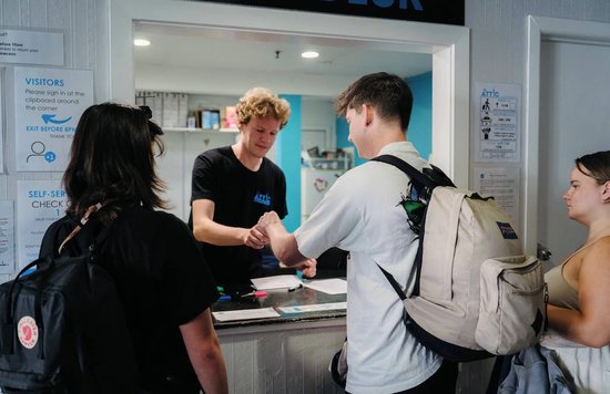 A friendly check-in experience at The Attic Backpackers in Auckland