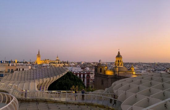 View of Seville skyline at sunset with Metropol Parasol and Seville Cathedral