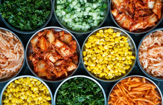 Assorted kimchi and vegetable side dishes in bowls | Photo Credit: Shaun Tilburg on Unsplash